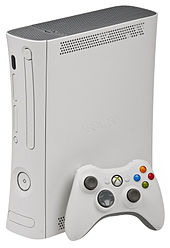 Xbox 360 Arcade console with white wireless controller.